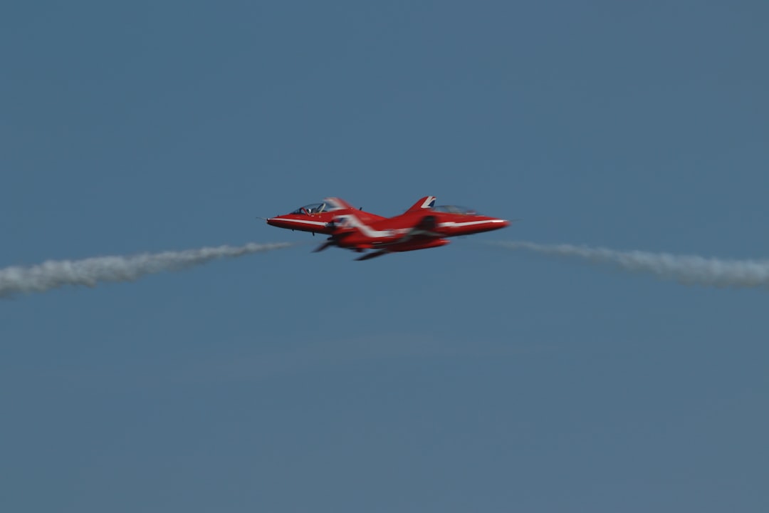 red-jet-aircraft-performing-aerobatics-with-smoke-trails-gz5yt3mcaia